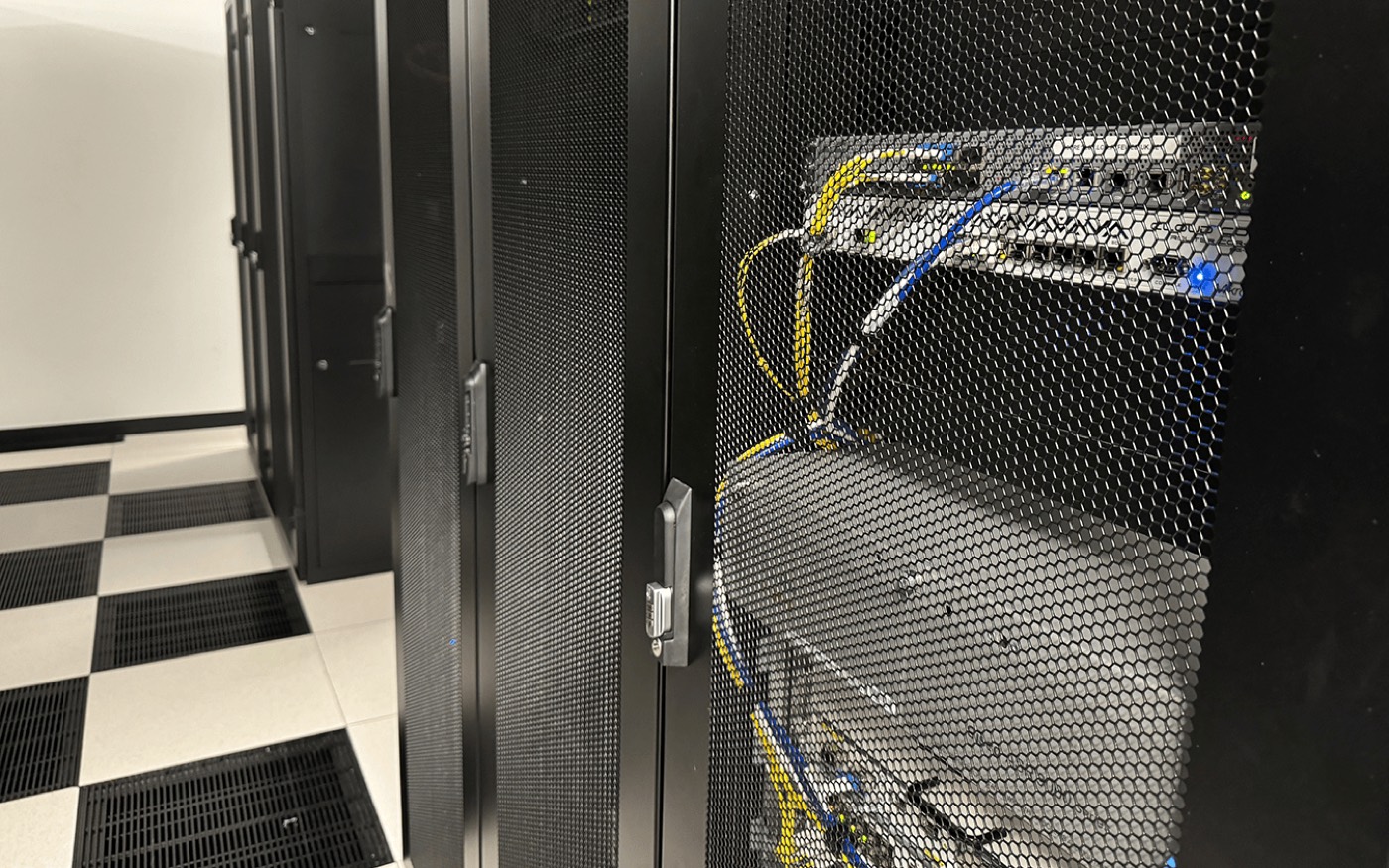 A cold-aisle of racks in a FyfeWeb UK data centre