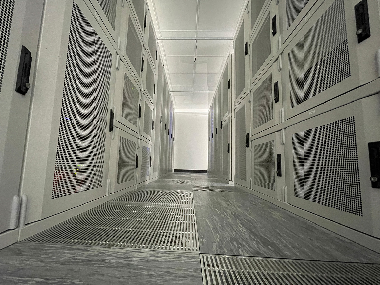 A rack aisle with locked colocation cabinets in a FyfeWeb data centre suite