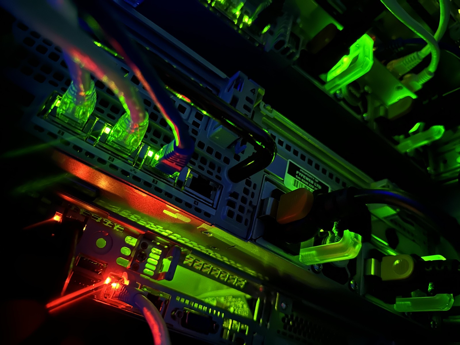 Patch cabling glowing green and red across FyfeWeb network gear