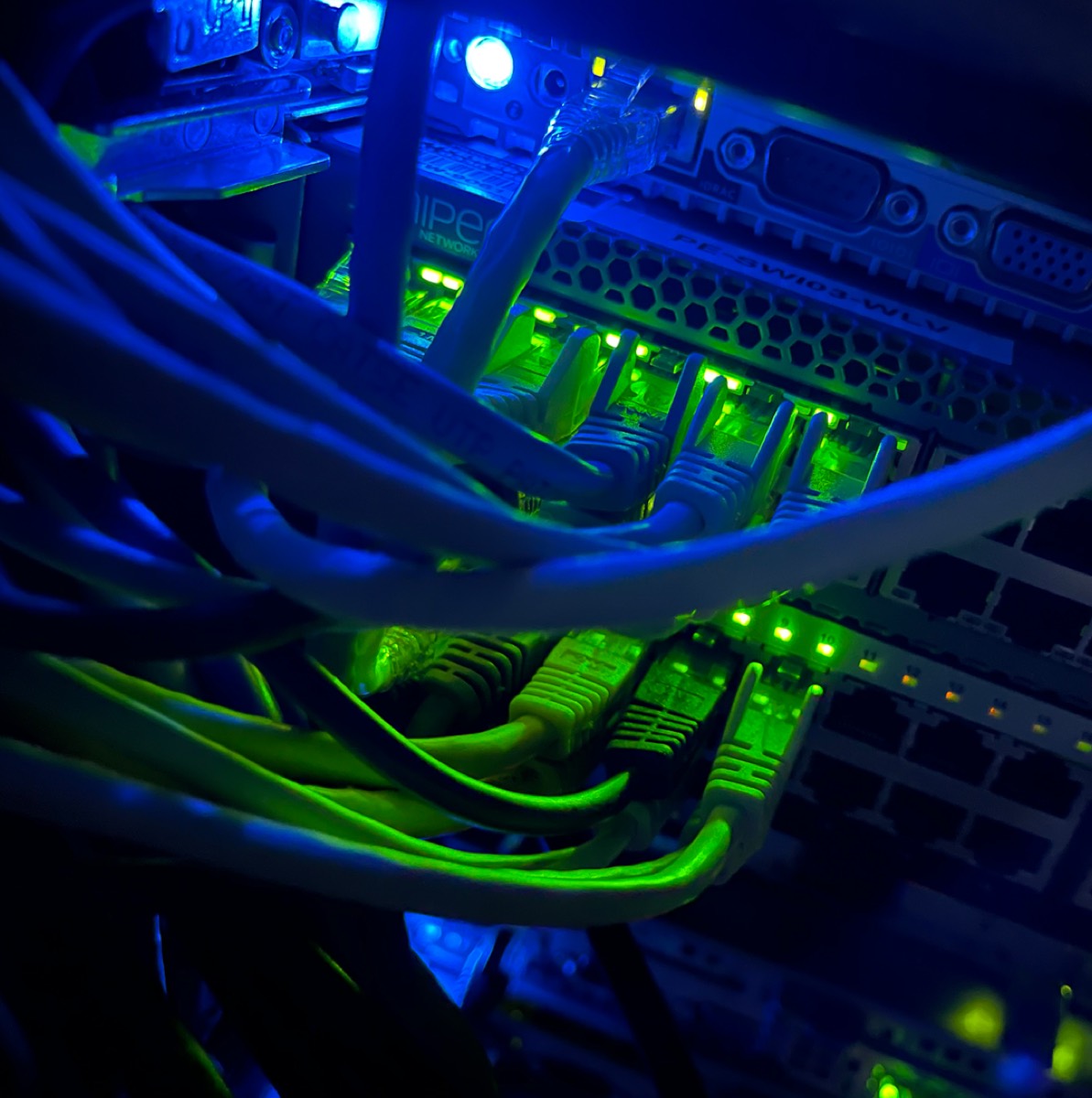 Network cabling and switch ports lit up inside a FyfeWeb hypervisor node